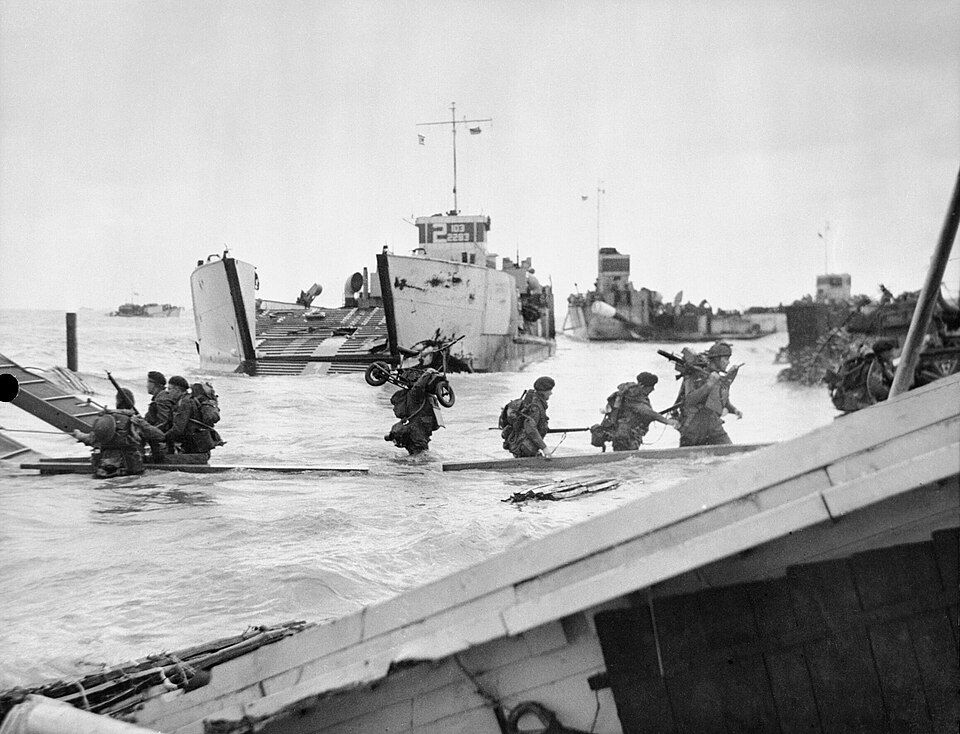 Commandos of 48 (RM) Commando come ashore from landing craft at St Aubin-sur-Mer. Royal Marines also crewed landing craft on D-Day.